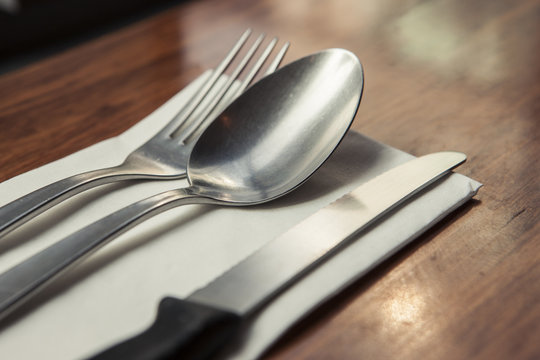 fork and spoon, knife on the wood table.