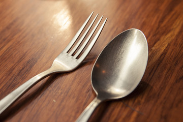 fork and spoon, knife on the wood table.