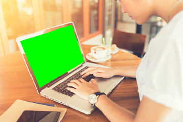 Female working on laptop in a cafe.