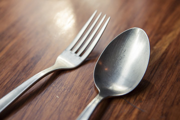 fork and spoon, knife on the wood table.