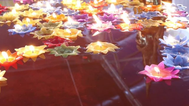 Floating candle in Thai temple for good fortune