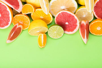 on top of juicy pieces of citrus fruit on a green background