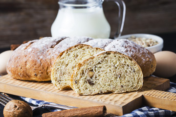 Top view of sliced wholegrain bread on a wooden cutting board.