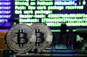 The digital process of cryptocurrency mining by using the GPUs. Bitcoins and video card on a...