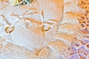 wedding rings on a white pillow white