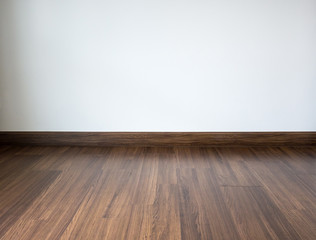 Empty room with laminate floor and white wall background