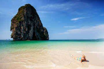 Fototapeta na wymiar Woman laying on tropical beach.