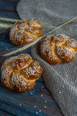 Buns with sesame seeds on a wooden background top view