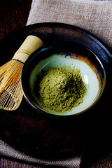 Still life with green tea and Japanese wire whisk made of bamboo for tea ceremony