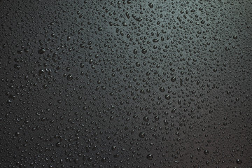Small liquid drops on a black background. - obrazy, fototapety, plakaty