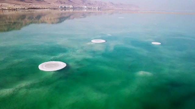 Aerial footage of the Dead Sea hotels and beaches area (lowest place on earth), flying above the salty water