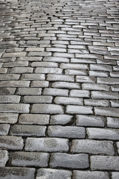 Fototapeta Antique wet cobblestone street at dawn. Vintage background.