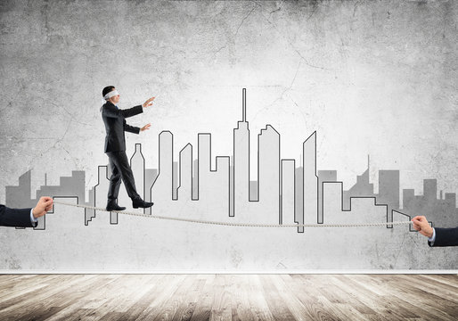 Business concept of risk support and assistance with man balancing on rope