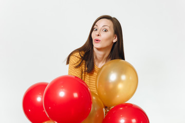 Fototapeta na wymiar Beautiful caucasian fun young happy woman in yellow clothes with shy charming smile, red, golden balloons, celebrating birthday, on white background isolated for advertisement. Holiday, party concept.