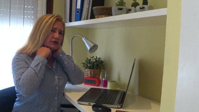 Tired businesswoman with neck pain
