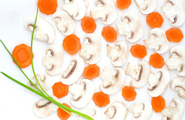 Sliced mushrooms, carrot, black pepper and green onion on white background