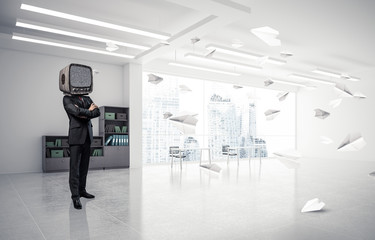 Businessman with an old TV instead of head.