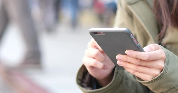 Woman sending sms on cellphone