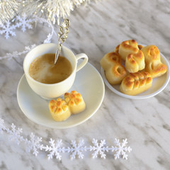 Figuritas de marzapan, Spanish Christmas marzipan sweets and cup of coffee on kitchen table with  christmas decoration. Traditional xmas treat consumed during winter holidays in Spain.
