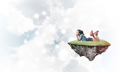 Concept of careless happy childhood with girl dreaming about som