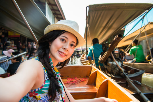 attractive young female tourist taking selfie