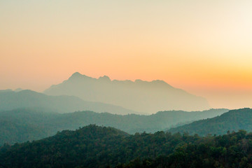 Landscape of mountain layer in morning sunrise and winter fog