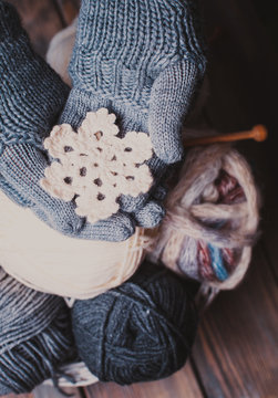 Hands in knitted gloves