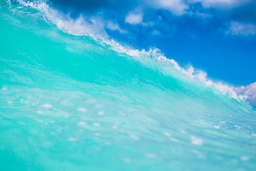 Blue or turquoise ocean wave. Clear wave in tropics and blue sky