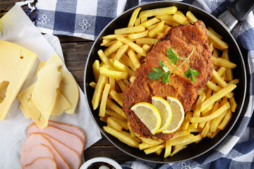 Cutlet Cordon Bleu with French fries, close-up
