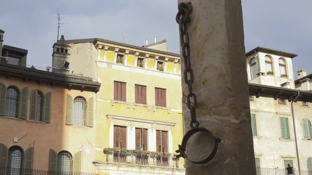 Old column with Antique hanging  Pillory Handcuffs on  La Tribuna in Piazza delle Erbe in Verona