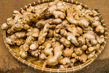 Bunch of Turmerics in the tray on the wooden table