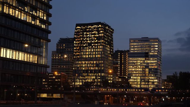 Traffic, trains and offices at night in the business district called 'Zuidas' in Amsterdam.
