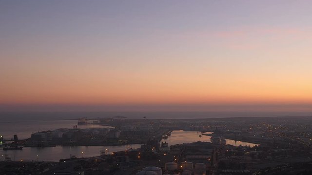 Industrial port Barcelona at dusk. Wide top view with ocean.