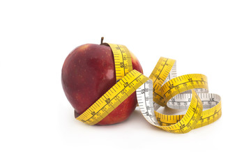 Red apple and measuring tape on a white background