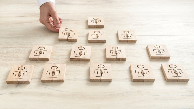 Human resources concept with a businessman arranging a series of wooden blocks