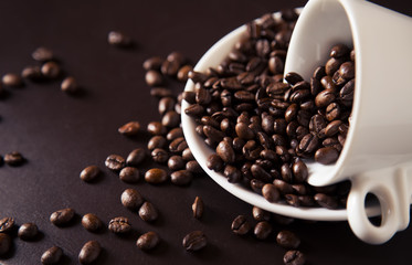 Coffee cup and coffee beans on old wooden background