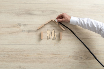 Expert holding a stethoscope on a family house