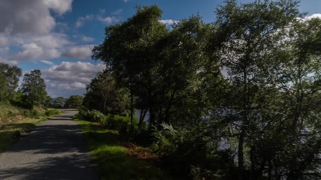 POV shot from a camera attached to the front of a vehicle driving through beautiful empty roads in the scottish highlands
