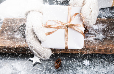 Packaging modern christmas present boxes. Hands with christmas gift. Celebration concept.