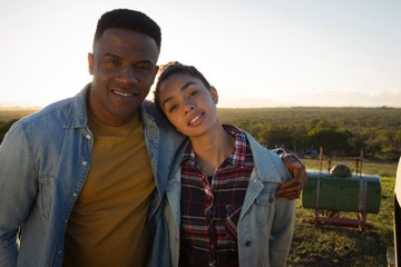 Portrait of couple standing together at countryside 