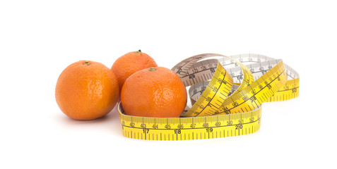 Orange mandarin and measuring tape on white background