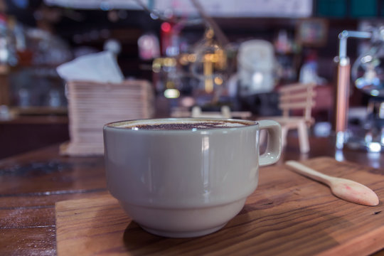 Cup of coffee on wooden dable in the coffee shop.