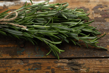 Fresh rosemary bunch on wood