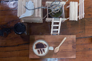 Cup of coffee on wooden dable in the coffee shop.