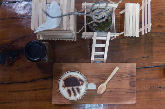 Cup of coffee on wooden dable in the coffee shop.