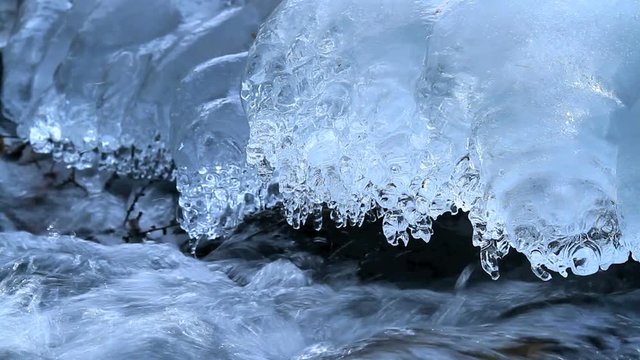 Rapid flow of water in a mountain river in winter.