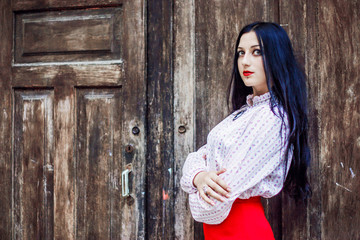 Fototapeta premium .A pretty girl in a red skirt poses
