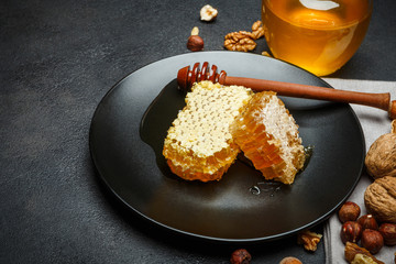 Honeycomb with honey on plate. dark concrete background