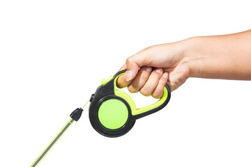 Hand holding black and green retractable dog leash on isolated white background