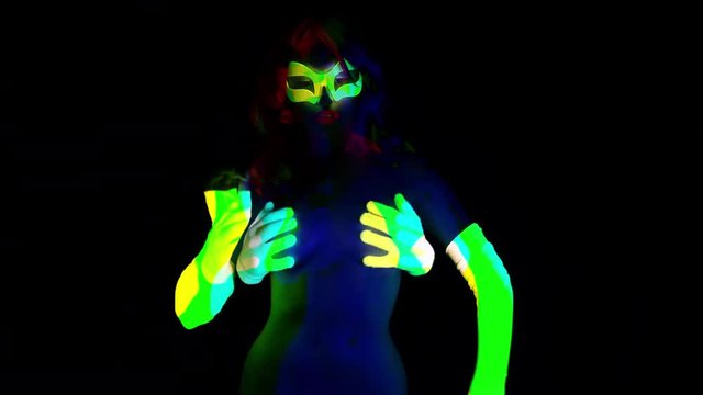 sexy cyber raver woman filmed in fluorescent clothing under UV black light with extra hands on her body